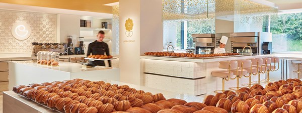 Freshly baked viennoiserie on the counter in front of the open kitchen