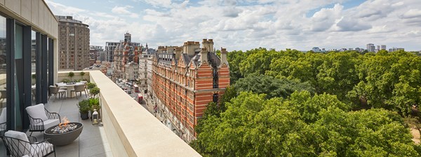 Terrace with two chairs looking out to red brick buildings on Knightsbridge and Hyde Park